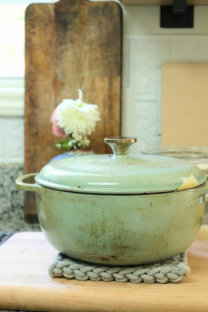 bread-inside-a-dutch-oven-with-lid-on-and-parchment-paper-sticking-out