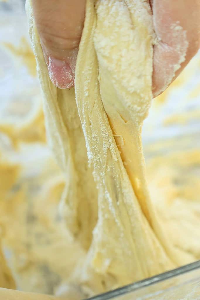 close-up-of-dough-being-pulled-out-to-form-artisan-loaf