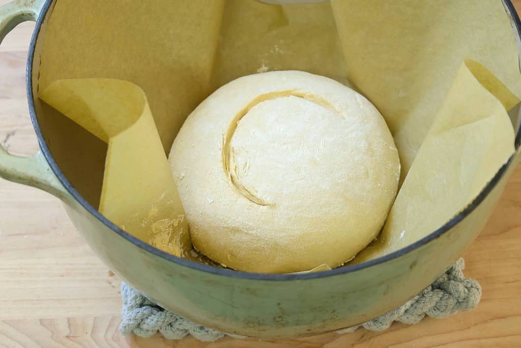 slashed-dough-on-parchment-inside-dutch-oven